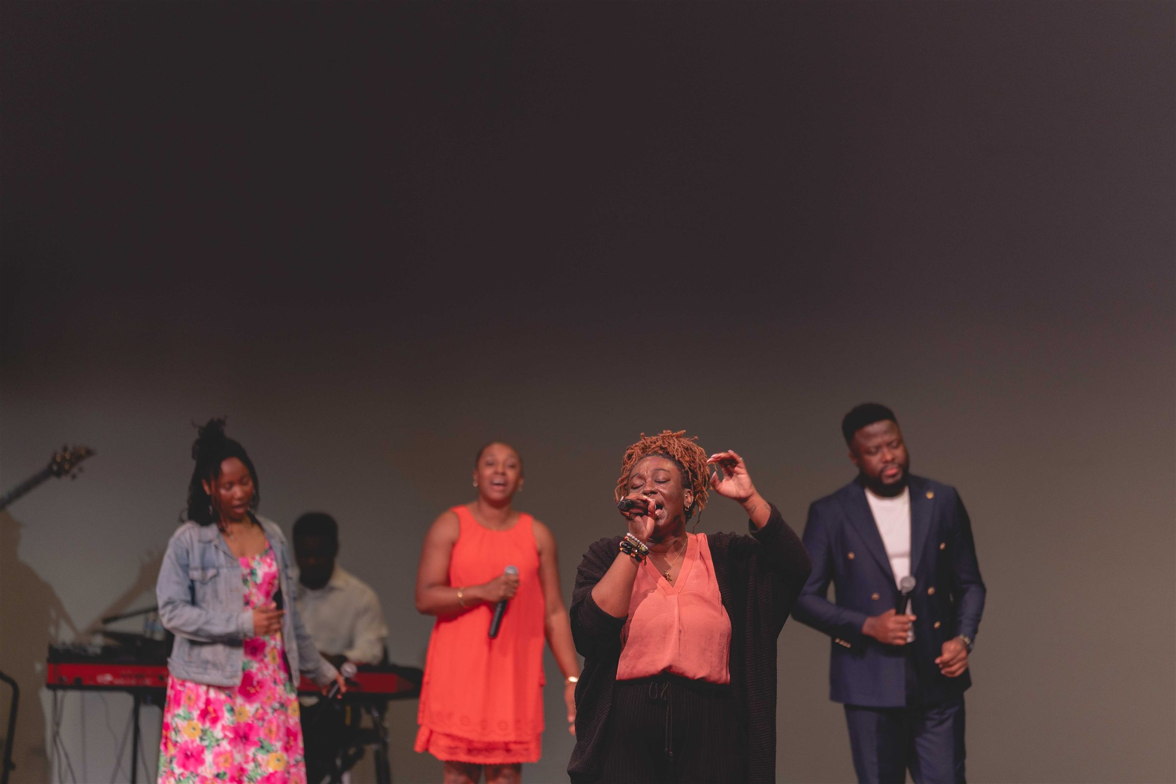 The vocal team leading worship on stage